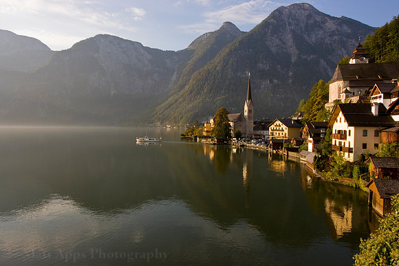 Boat sailing into the morning fog in Hallstatt, Austria